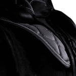 Close up of grey saddle pad with silver and diamante trim, modelled on a black horse with a dressage saddle.